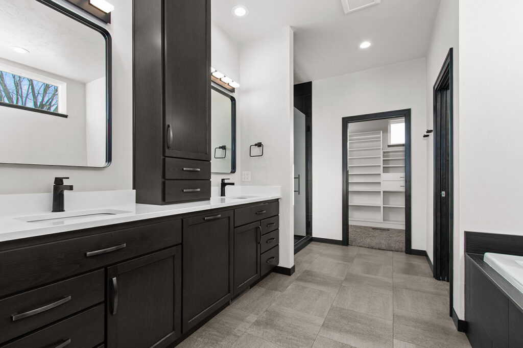modern-bathroom-with-silver-hardware-and-dark-double-vanity