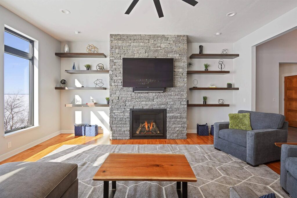 bright-living-room-with-built-in-shelves-and-stone-fireplace