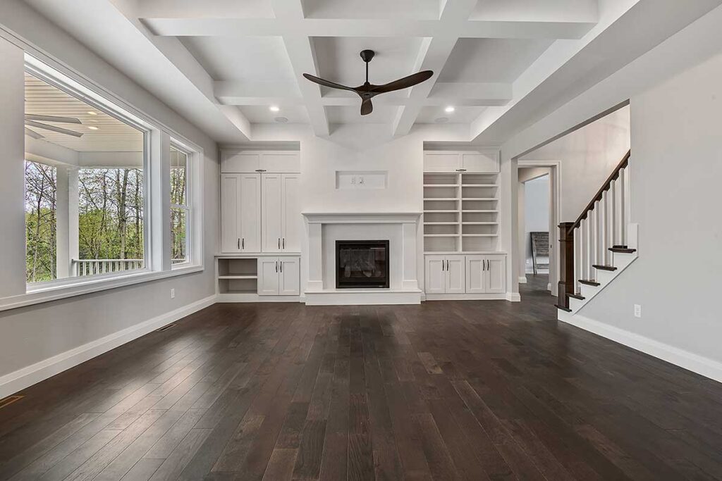 crisp-white-entertainment-space-with-large-built-in-and-fireplace