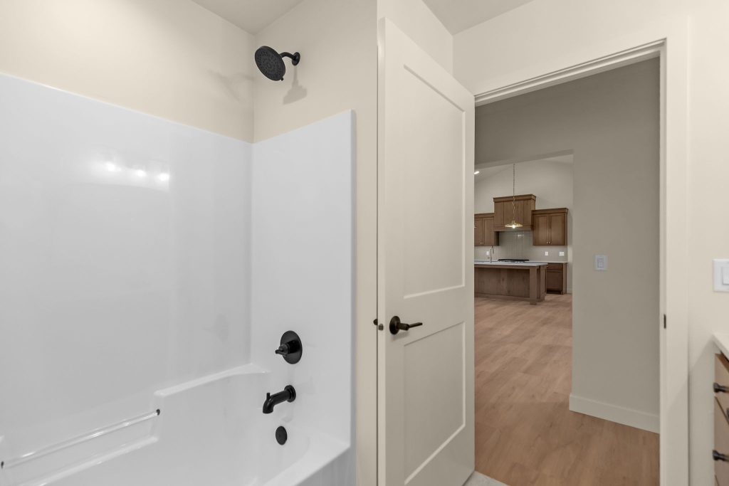 Bright children's bathroom with double vanity, bathtub and modern finishes