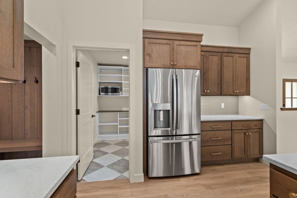Bright kitchen and pantry area with modern finishes and ample storage