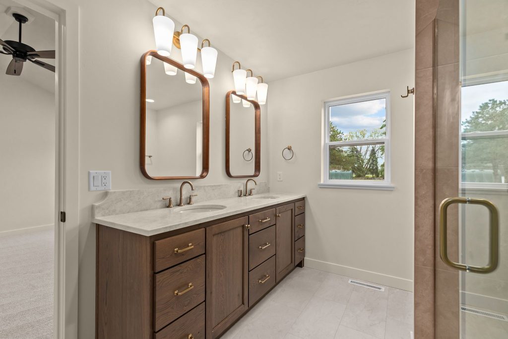 Spacious primary bathroom with double vanity, walk-in shower and modern finishes